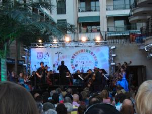 a crowd of people watching a band on a stage at Regina's Guesthouse in Balchik