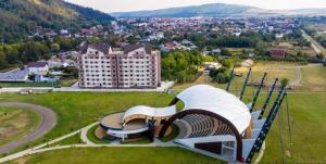 a building on a hill with a view of a city at Sofia Residence Apartments Cetate in Târgu Neamț