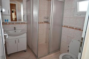 a bathroom with a shower and a toilet and a sink at Melis Pansiyon in Bodrum City +66 photos