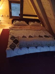 a bed in the attic of a room at Sicevacka Bajka in Niš