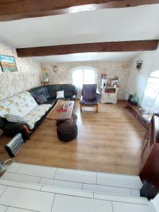 a living room with a couch and a table at Maison de charme à Autignac avec vue sur jardin et montagne in Autignac