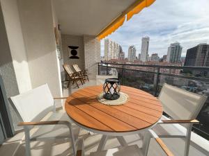 a table and chairs on a balcony with a view of a city at Gemelos 24 Cala de Finestrat. Luxury Apt. in Benidorm