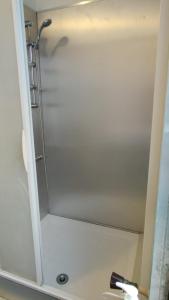 a shower in a bathroom with a mirror at TONY House in Bondy +4 photos