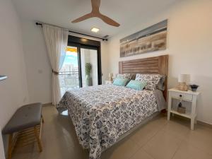 a bedroom with a bed and a window at Gemelos 24 Cala de Finestrat. Luxury Apt. in Benidorm
