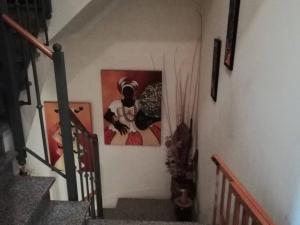 a stairway with a painting on the wall and some stairs at Global Guests in Sintra