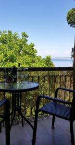 a table and chairs sitting on a balcony with a table and chairs at Ascension Corfu Studios by GuestCorfu in Análipsis