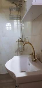 a bathroom with a white sink with a faucet at Ascension Corfu Studios by GuestCorfu in Análipsis +18 photos