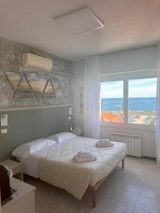 a bedroom with a bed with a view of the ocean at La Casa sul Mare - Monterosso - Cinque Terre in Monterosso al Mare
