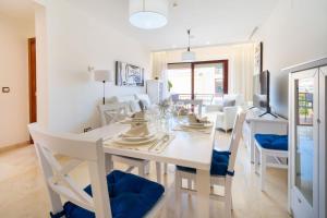 a white dining room with a white table and chairs at Apartamentos Albir Confort 3 dormitorios in Albir