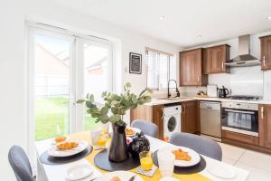 a kitchen with a table with food on it at Captivating 3-Bedroom House with Netflix and Parking by HP Accommodation in Kibworth Harcourt