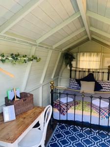 a bedroom with a bed and a table in a room at Penhallow House in Newlyn East