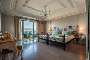 a bedroom with a bed and a chandelier at MFB Tarabya Hotel in Istanbul