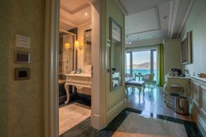 a hallway with a room with a sink and a mirror at MFB Tarabya Hotel in Istanbul +37 photos