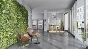 eine Lobby mit Stühlen und einer grünen Wand in der Unterkunft Nena Apartments München City - NEW OPENING 2024 in München