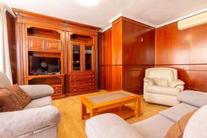a living room with two couches and a tv at Apartamento Ático Duplex Santa Pola in Santa Pola