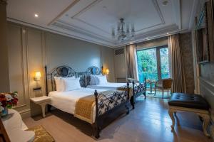 a bedroom with a large bed with a chandelier at MFB Tarabya Hotel in Istanbul