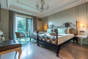 a bedroom with a bed and a table and a chair at MFB Tarabya Hotel in Istanbul