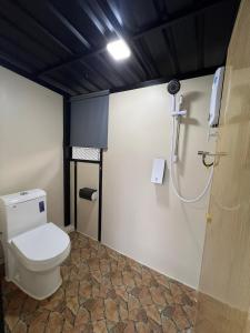 a bathroom with a toilet and a shower at Glamping at Xscape Tambun in Tambun
