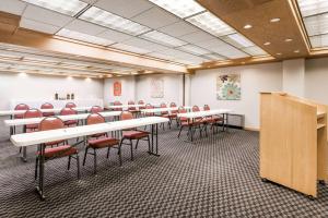 a conference room with tables and chairs and a podium at Super 8 by Wyndham State College in State College