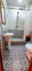 a bathroom with a sink and a shower and a toilet at Naqshband in Bukhara