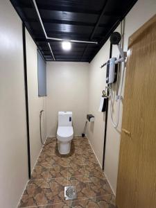 a bathroom with a toilet in a room at Glamping at Xscape Tambun in Tambun