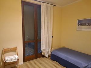 een slaapkamer met een bed en een glazen schuifdeur bij The Green House in Troghi in Troghi