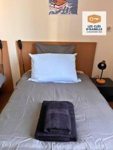 ein Bett mit einem blauen Handtuch darüber in der Unterkunft Appartement climatisé avec sa terrasse de 25 M2 in Limoges