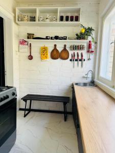 a kitchen with a counter and a bench in it at LauvasNams in Dubeņi