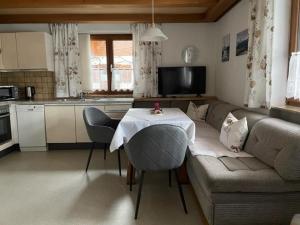 a living room with a table and a couch at Haus Elisabeth Schwaiger in Maria Alm am Steinernen Meer
