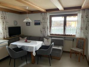 a living room with a table and a couch at Haus Elisabeth Schwaiger in Maria Alm am Steinernen Meer