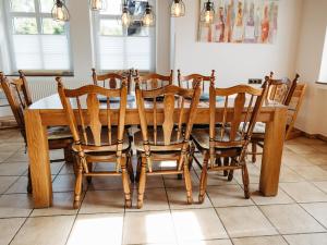 a wooden dining room table with chairs around it at Ferienwohnung Wennetal in Schmallenberg