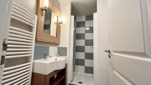 a small bathroom with a sink and a mirror at Argousiers 123 in Fort-Mahon-Plage