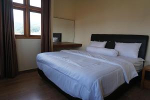 Ein Bett oder Betten in einem Zimmer der Unterkunft Cipada Guesthouse syariah