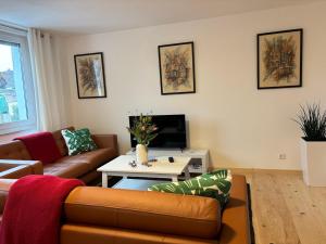 a living room with a couch and a coffee table at Wick Home Apartment 1 in Burgheim