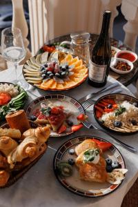 a table with plates of food and a bottle of wine at Hotel 28 in Bishkek