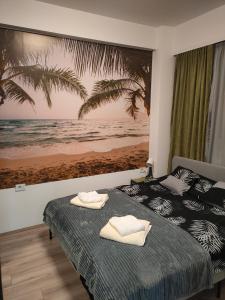 a bedroom with two beds and a painting of the beach at Apartment Tropical - Aqua Park Jagodina in Jagodina