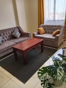a living room with a couch and a coffee table at Home away from home Next to Sky Louge Bamburi in Mombasa
