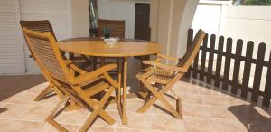 a wooden table with four chairs around it at Flamingo Vila Alicante in San Pedro del Pinatar