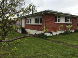 a brick house with a tree branch in front of it at Close to Picton Town in Picton