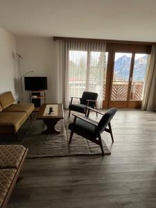 uma sala de estar com uma poltrona e uma mesa em Gemütliche Wohnung in Seelisberg em Seelisberg