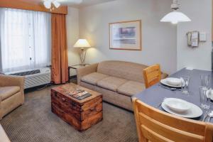 a living room with a couch and a table in a room at Hilton Vacation Club Varsity Club Tucson in Tucson