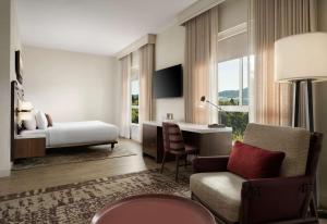 a bedroom with a bed and a desk and a chair at The Knoll Hotel Napa Valley, Tapestry Collection by Hilton in Napa