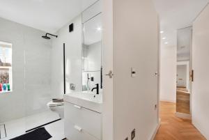 a white bathroom with a sink and a toilet at LUXURY NEW 1 bed SUITE BOND ST APART’M MAYFAIR in London