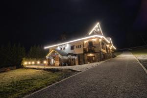 a large building with lights on it at night at Penzion Katarina in Ždiar