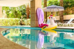 a pool with a unicorn float in the water at Suíte 5 estrelas Hotel Moema Times Square 1412 in Sao Paulo