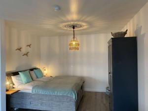 a bedroom with a bed with a cat sitting on top of it at Holiday apartment Beach54´Damp in Damp