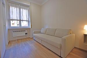 a living room with a couch and a window at CASA CRISTINA in Sanremo