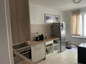a kitchen with a counter and a refrigerator at Im Herzen von Bochum in Bochum +3 photos