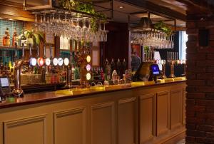 a bar with a lot of bottles of alcohol at Narborough Arms in Narborough