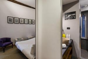a bedroom with a bed and a mirror at Alle Mura del Molo Apartment by Wonderful Italy in Genoa